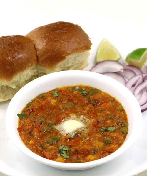 Premium Photo | Mumbai style pav bhaji is a fast food dish from india,  consists of a thick vegetable curry served with a soft bread roll, served  in a plate